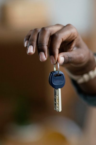 front-view-woman-holding-keys-her-new-home_23-2148814383
